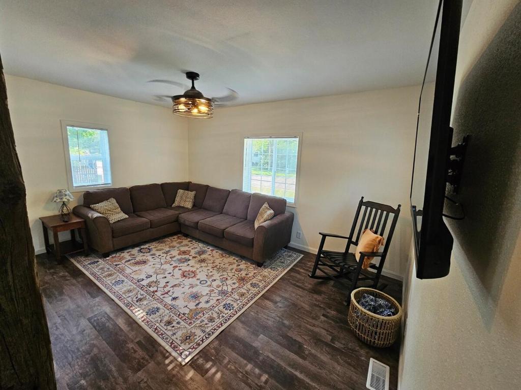 a living room with a couch and a rug at Moores Crystal Mountain Retreat in Thompsonville