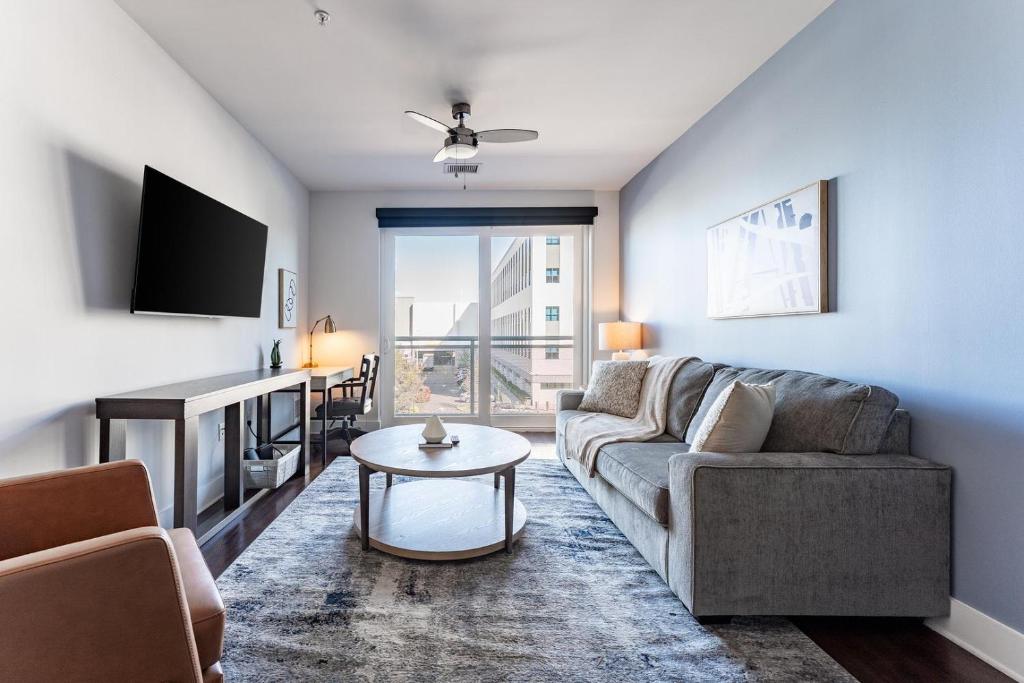 a living room with a couch and a table at Landing Chic 1BD Gym Rooftop Lounge in Orlando