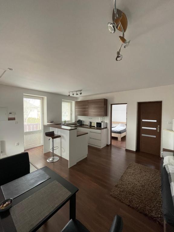 a living room with a couch and a table and a kitchen at Apartmany Star in Liptovský Mikuláš