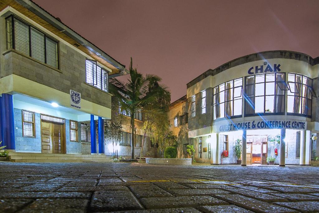 an empty street in front of a building at night at Chak Guesthouse & Conference Center in Nairobi