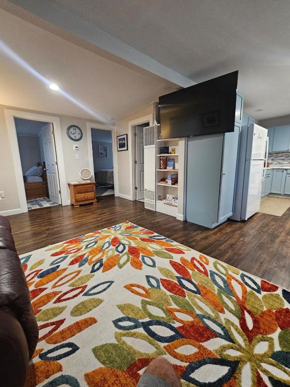 a living room with a rug on the floor at Less is Moore in Thompsonville