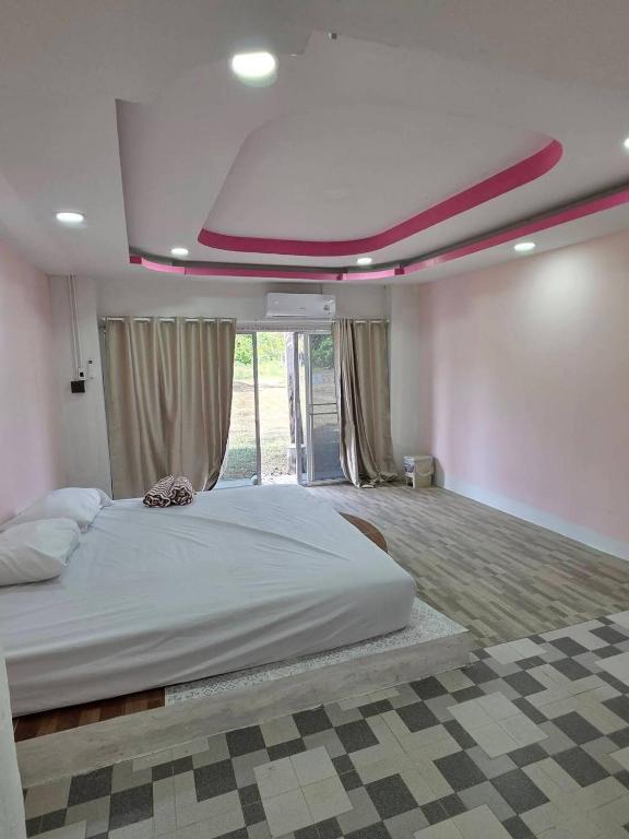 a bedroom with a large bed with a ceiling at Atchanin camping room 2 in Ban Samet