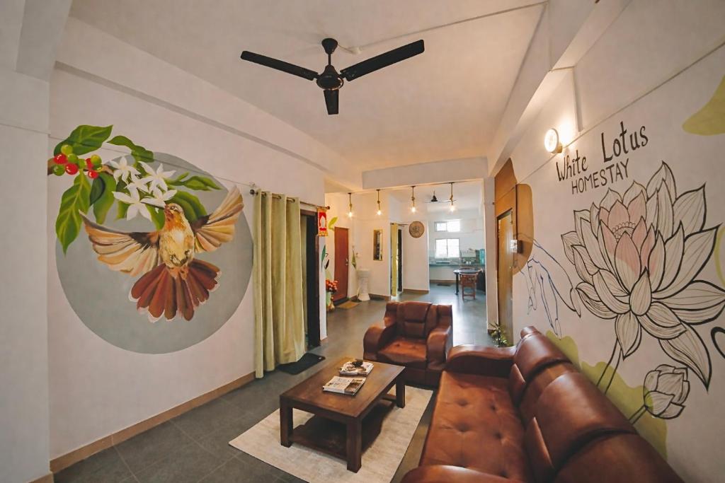 a living room with a couch and a flower mural at White Lotus in North Lakhimpur