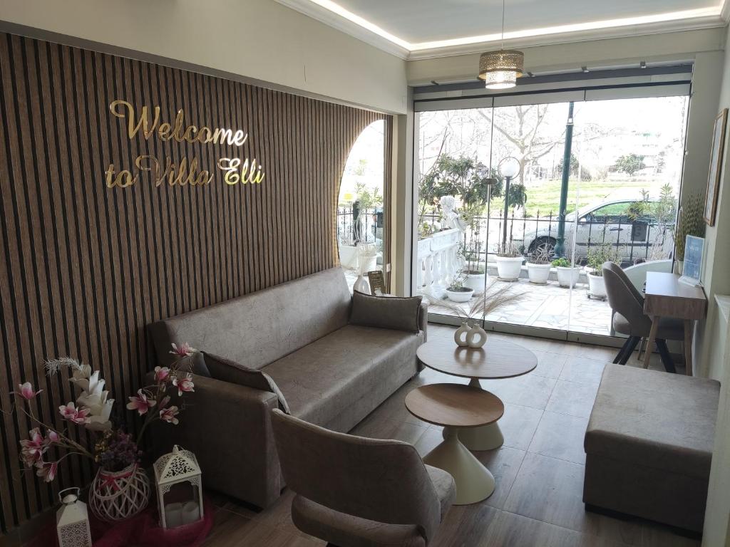 a living room with a couch and a table at VILLA ELLI with free private Parking in Olympic Beach