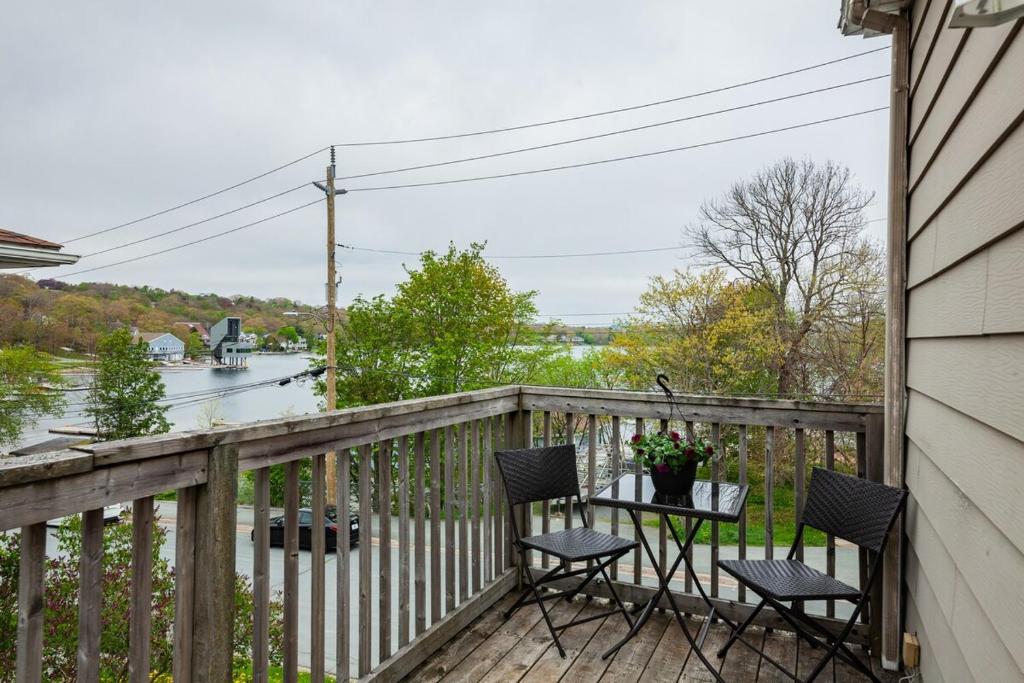 a balcony with two chairs and a table with flowers at Little Banook B&B in Halifax