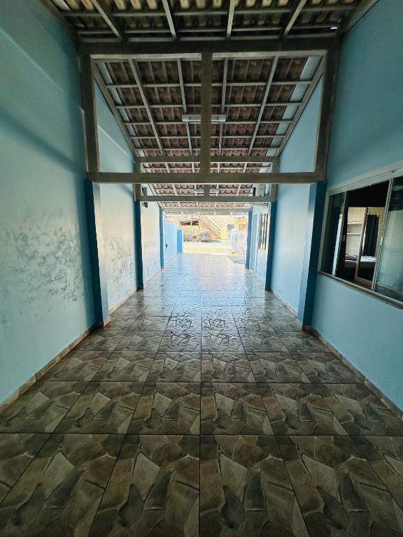 an empty hallway with a tile floor in a building at casapraia penha sc in Penha