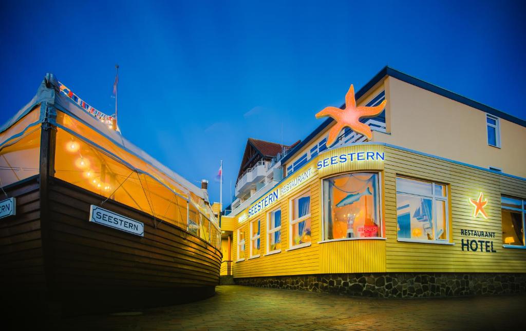 a yellow building with a star on top of it at Hotel Restaurant Seestern in Heiligenhafen