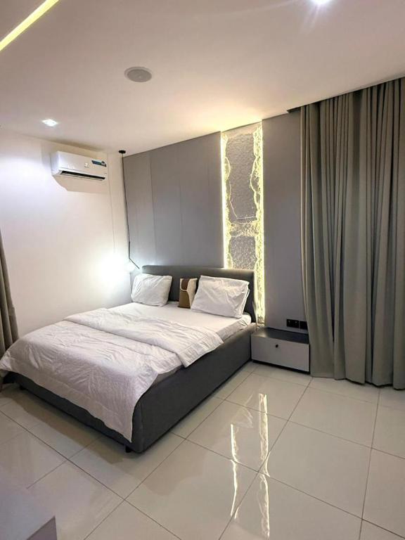 a bedroom with a large bed in a room at Cosmos in Lagos