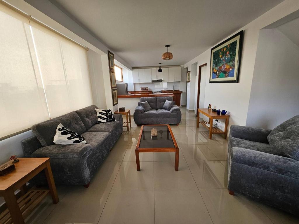a living room with two couches and a coffee table at Surfers Paradise - Casa Caro in Punta Negra