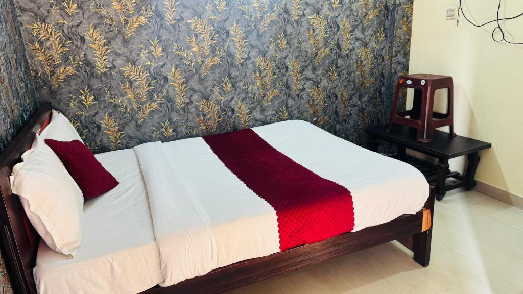a bedroom with a bed and a table with a mirror at Delight rooms in Mysore