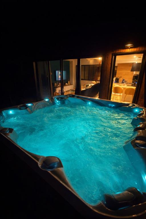 a jacuzzi tub with lights in a room at L Usine Loft Spa Privé Centre Ville et garage Privé in Concarneau