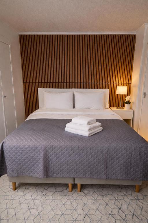 a bed with towels stacked on top of it at Stilla Hem 2 in Tranemo