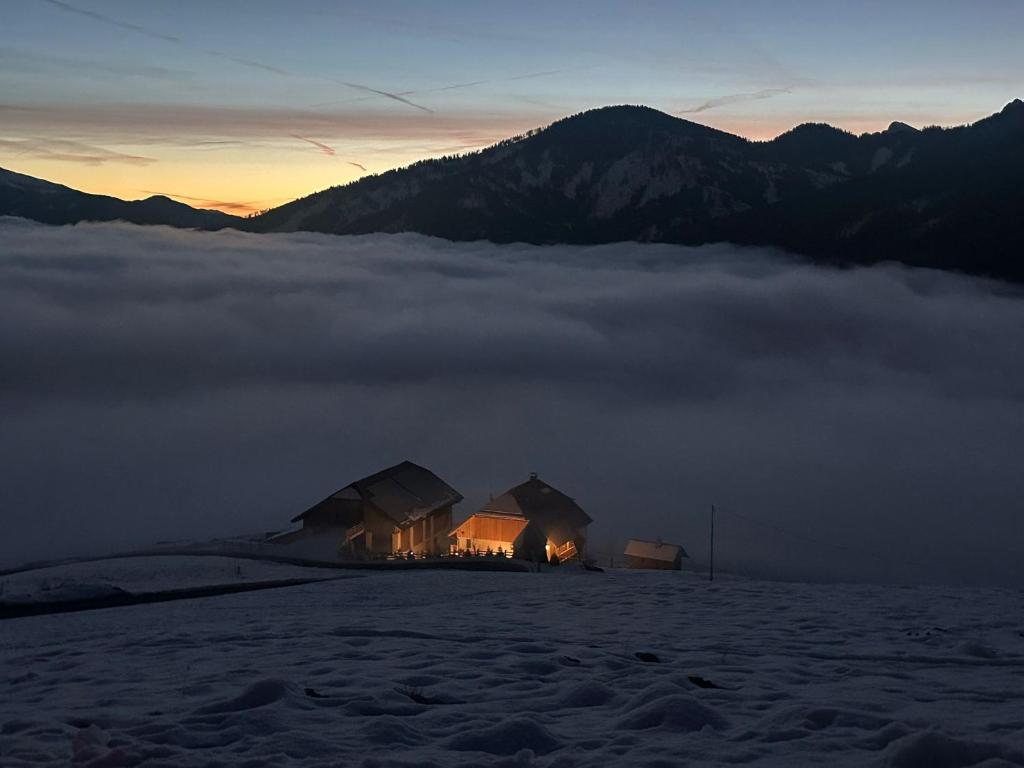a house on top of a mountain with a layer of clouds at Sorafurcia Lodge in Sorafurcia