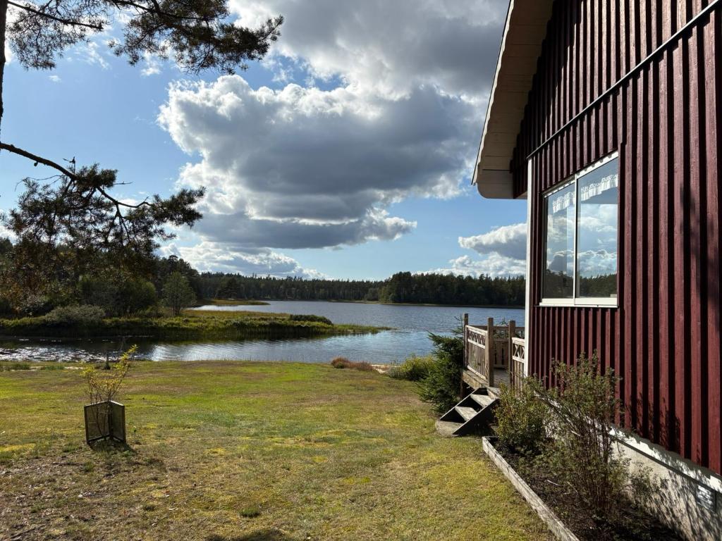 a building with a view of a body of water at Åker Lilläng Strandstugan in Åker