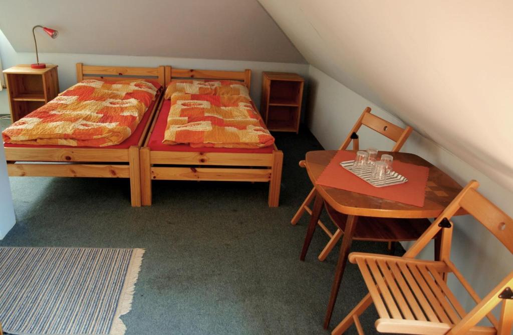 a bedroom with a bed and a table and a tableablish at Hostel Skautský dom in Banská Štiavnica