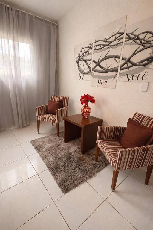 a living room with two chairs and a table at Apartamento simples e Familiar conforto e sossego in João Pessoa