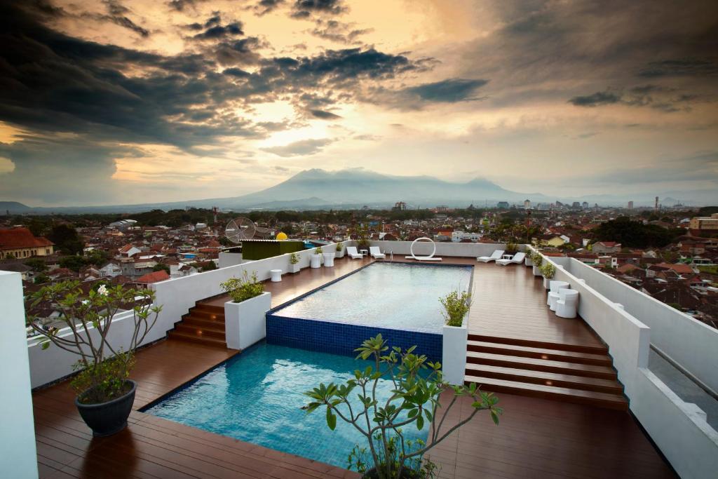 a view from the roof of a building with a swimming pool at Ascent Hotel & Cafe Malang in Malang