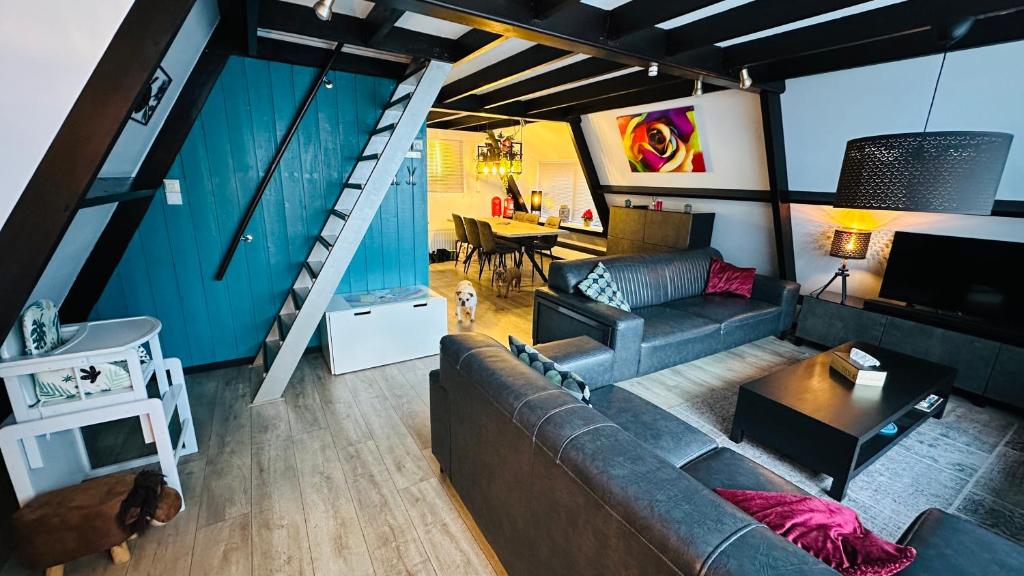 a living room with a couch and a table at Villa Edice met zwembad en restaurant in Durbuy - honden toegelaten in Durbuy
