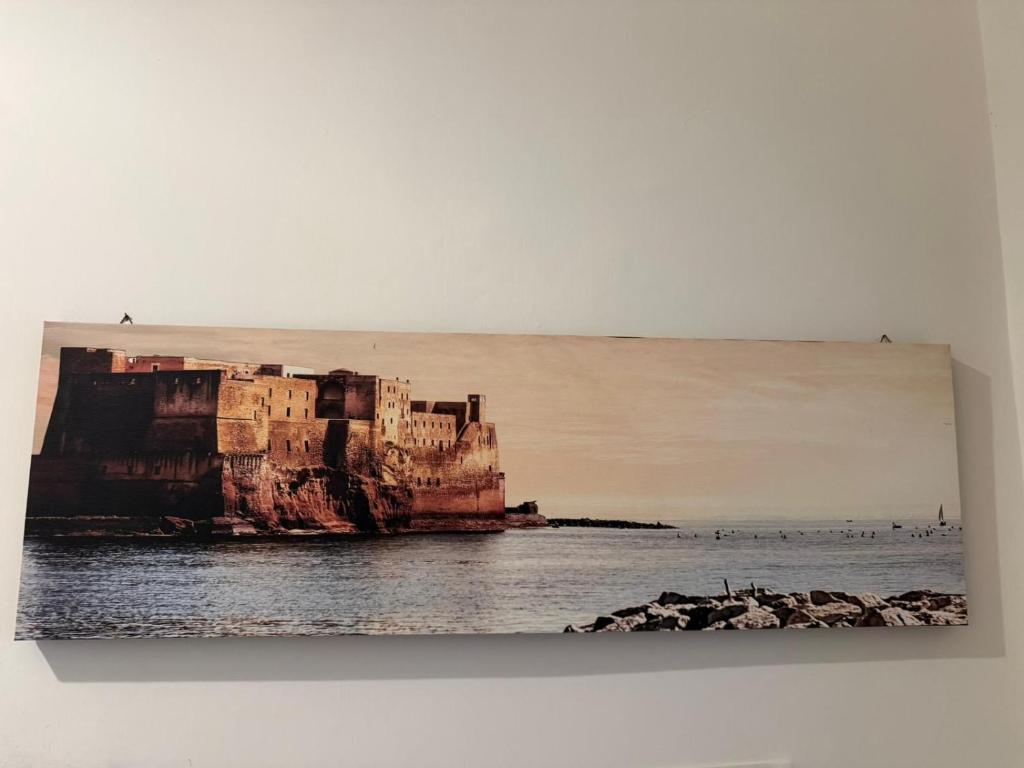 a painting of a cliff in the water at Da Alfred in Naples