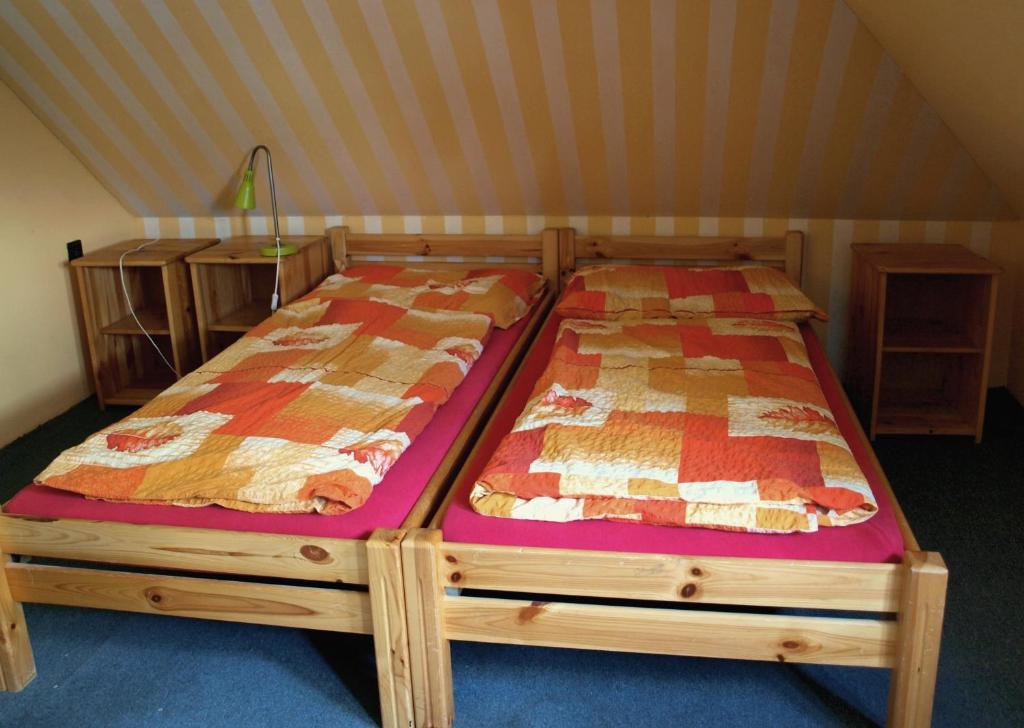 a wooden bed in a room with at Hostel Skautský dom in Banská Štiavnica