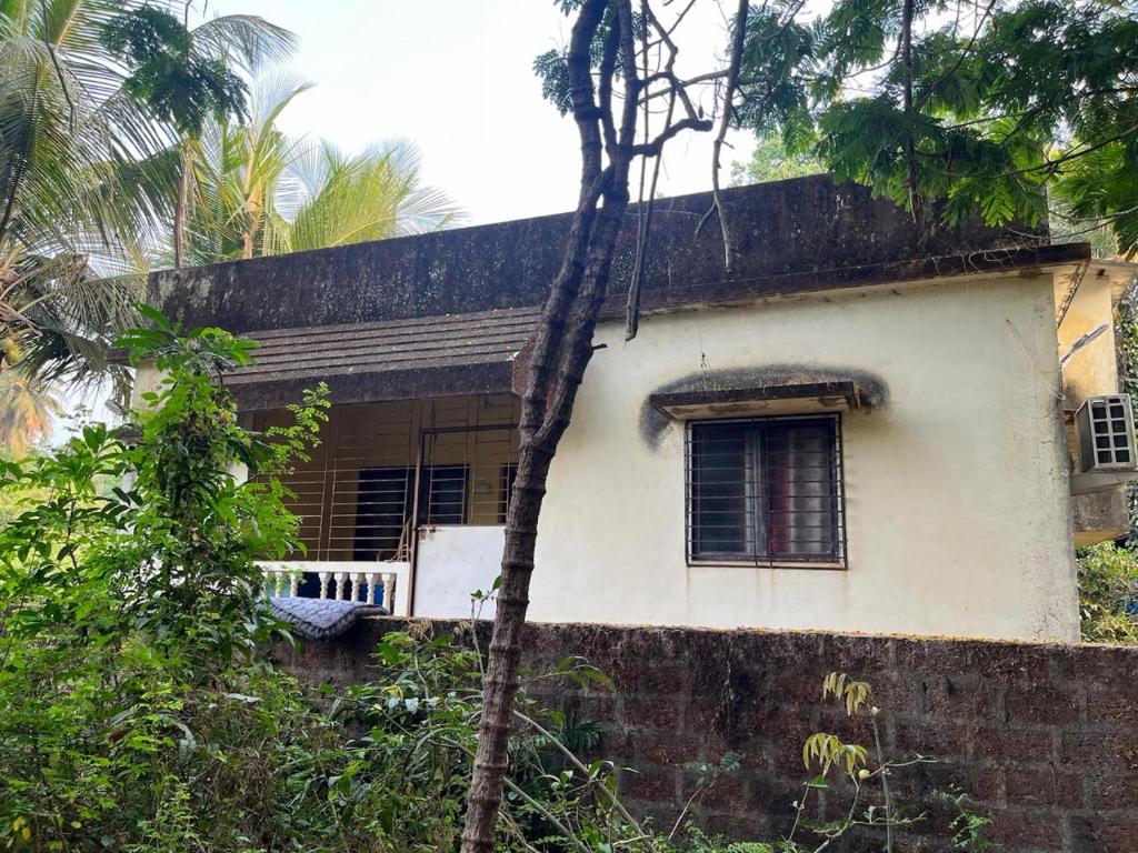 a small house with a window and a fence at Prakash Banglow in Malvan