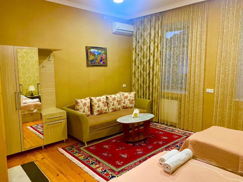 a living room with a couch and a table at HOTEL JULIA Akhaltsikhe in Akhaltsikhe