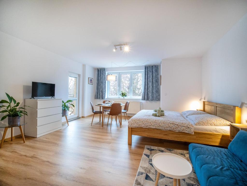 a bedroom with a bed and a living room at Apartmán Ve středu dění in Poděbrady