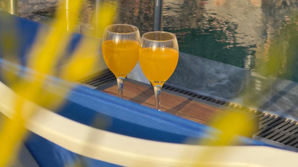 two glasses of orange juice sitting on a conveyor belt at Villa Aden in Fethiye