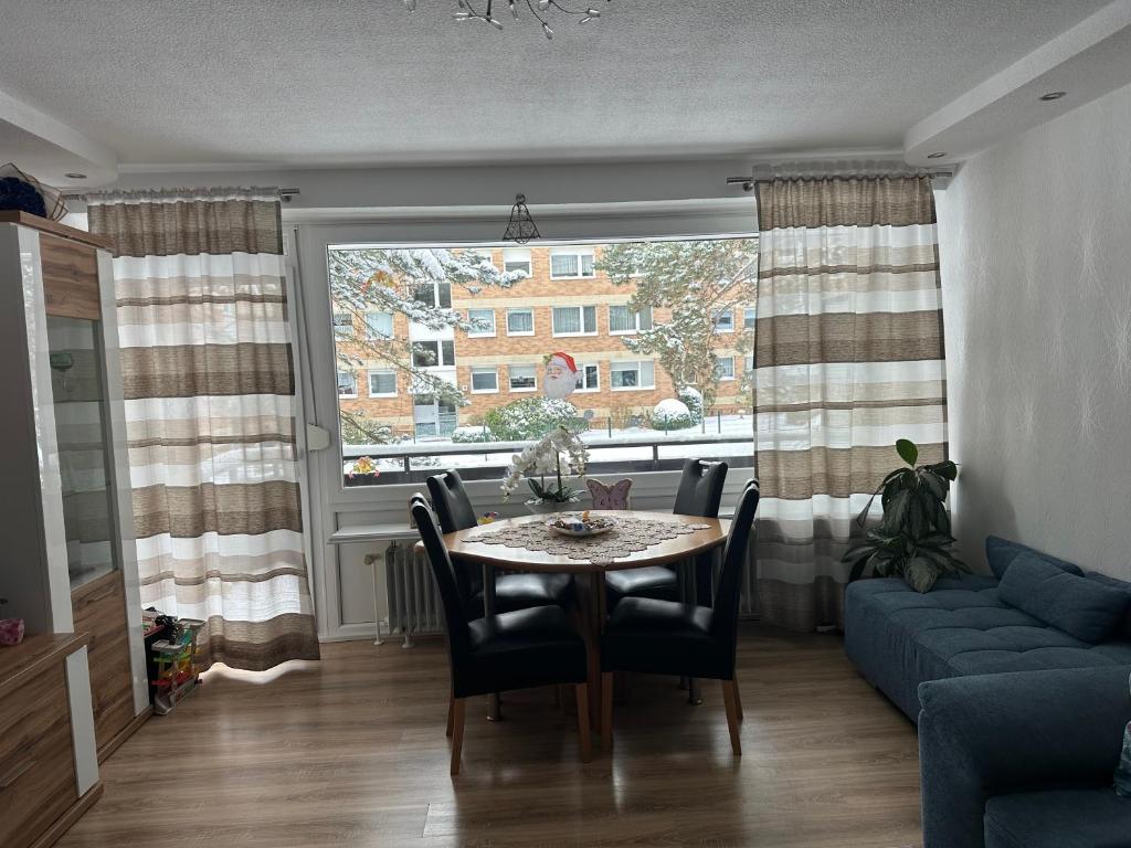 a living room with a table and a couch and a window at Apartment Rita in Hannover