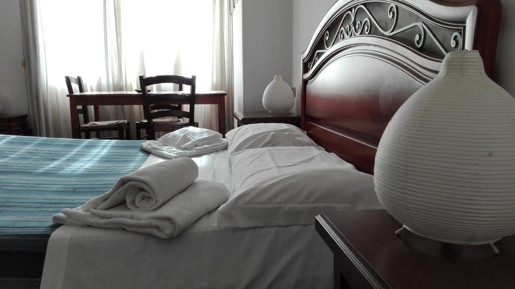 a bedroom with a bed with white towels on it at Elion in Rome