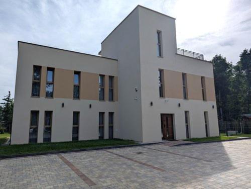 a large white building with a lot of windows at Apartamenty Biwakowa 4B in Turawa