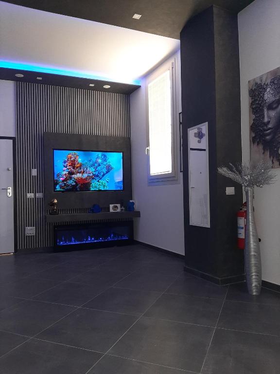 a living room with a flat screen tv on a wall at LuX Apartments in Lugo