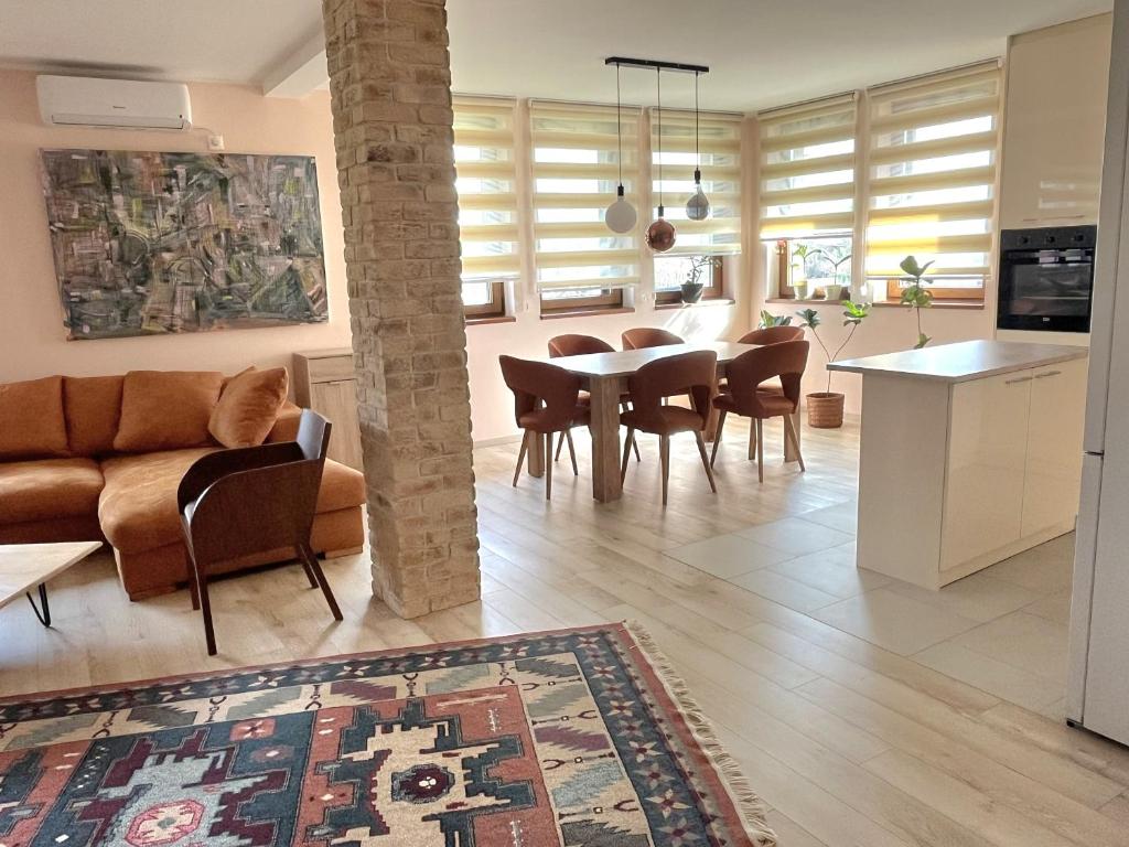 a kitchen and living room with a table and chairs at Pista house in Beograd
