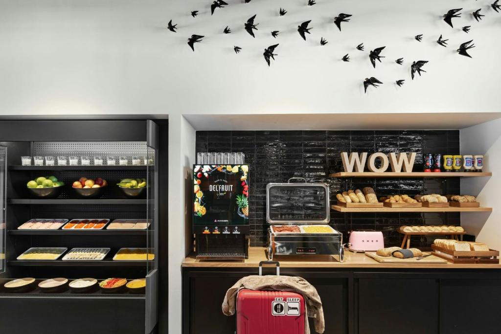 A playful breakfast and bakery station with hot food, fruit and pastries.