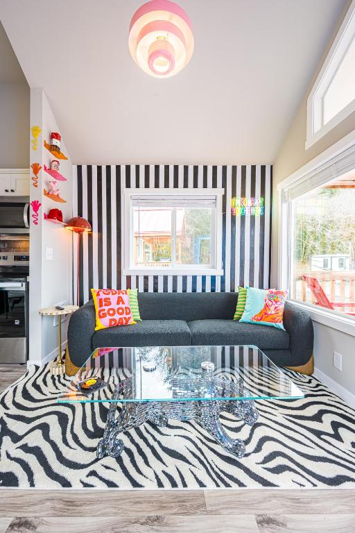 a living room with a couch and a zebra rug at Rainforest Tiny Home Retreat #17 Abstract Modern in Forks