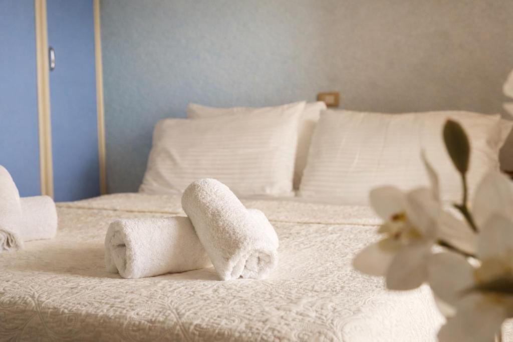 a bed with two rolled towels on it at Hana's Apartment in Durrës
