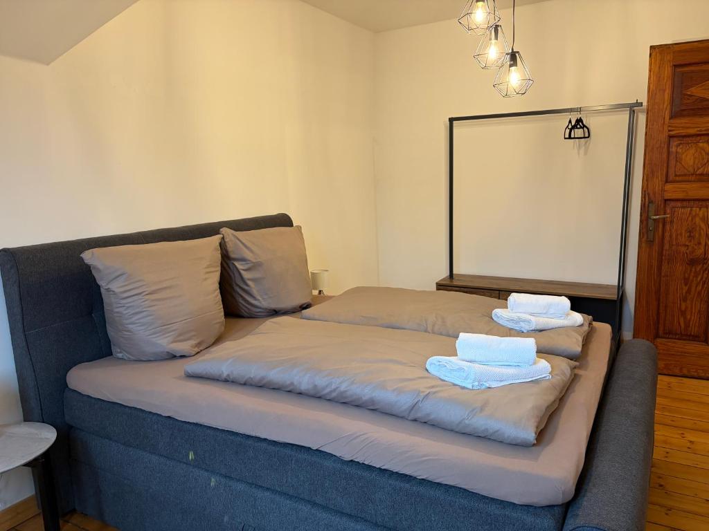 a bed with towels on top of it in a room at Business Apartment in Paderborn