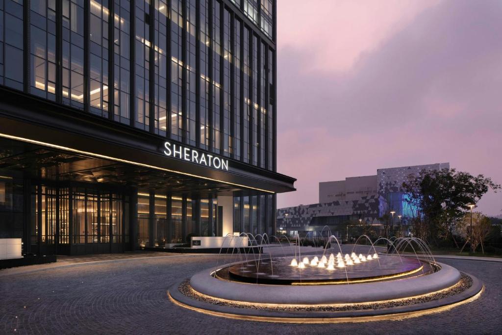 a building with a fountain in front of a building at Sheraton Ningbo Yinzhou in Ningbo
