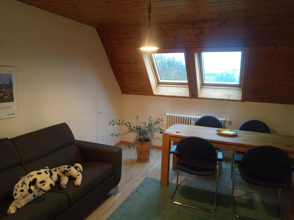 a living room with a couch and a table at Gästezimmer Stadtpark in Biel