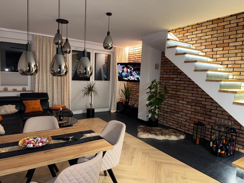 a living room with a staircase and a couch at S Golf Apartament in Gowinko