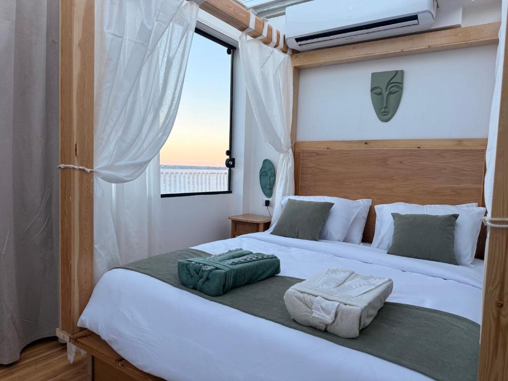 a bedroom with two beds and a window at Casa Luna Beach-Front Suite in Dahab