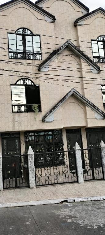 a building with windows and a fence in front of it at La Pradera in Pereira