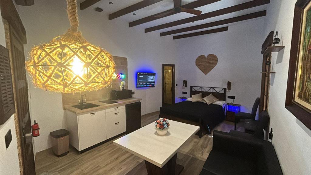 a living room with a bed and a dining room at La Posada del Diezmo in Manzanilla