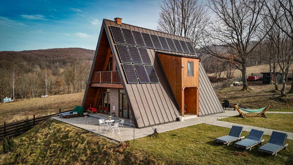 a small house with solar panels on its roof at Dream Cottage in Paltin
