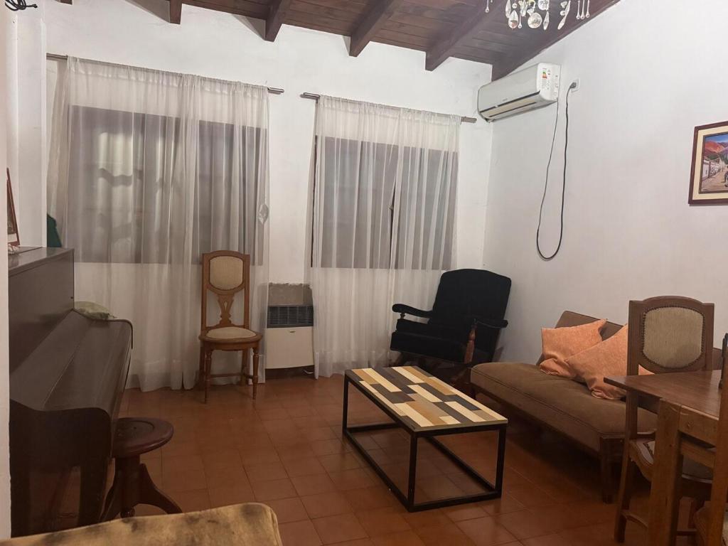 a living room with a couch and chairs and a table at Moon of Salta in Salta