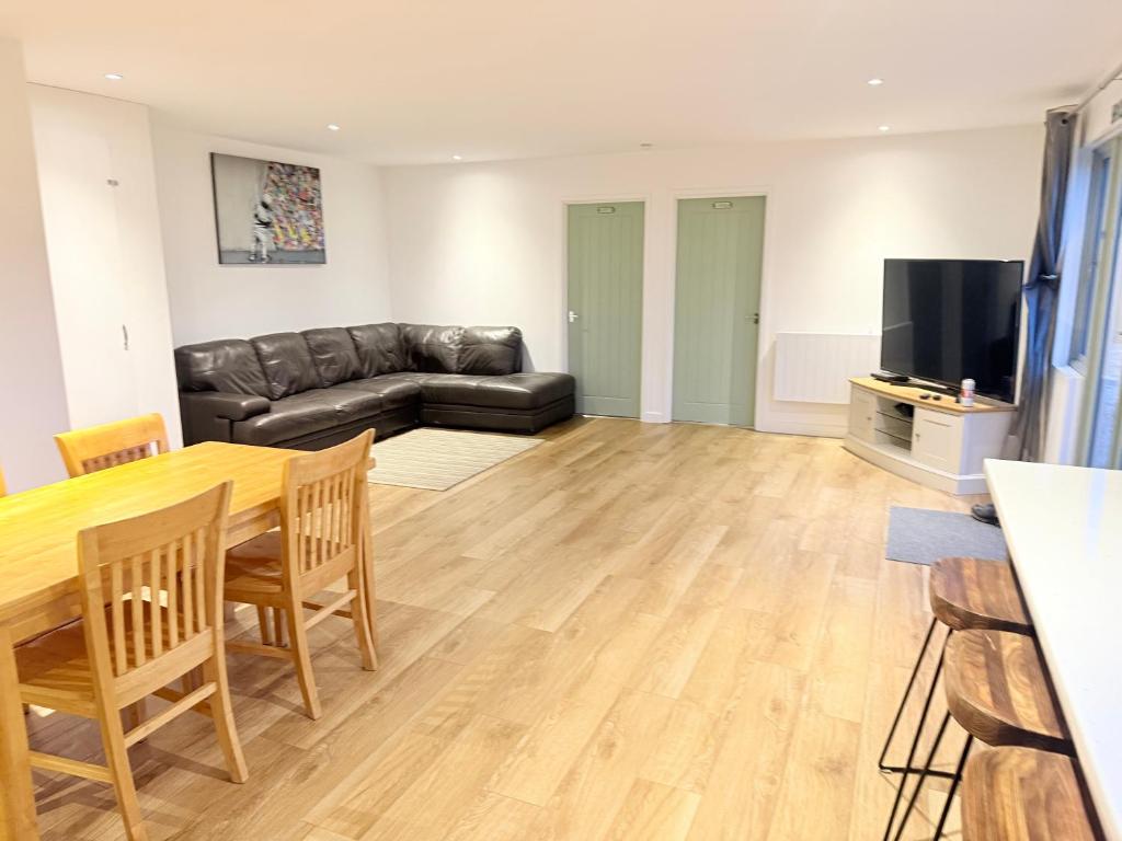 a living room with a table and a couch at Poplar holiday cottage in Moulton Chapel