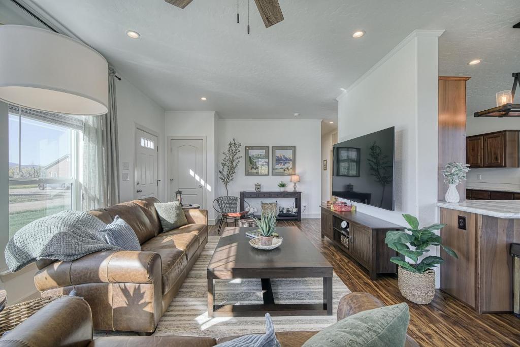 a living room with a couch and a table at 2 BR King Bed Hot Tub AC Near Jackson in Victor