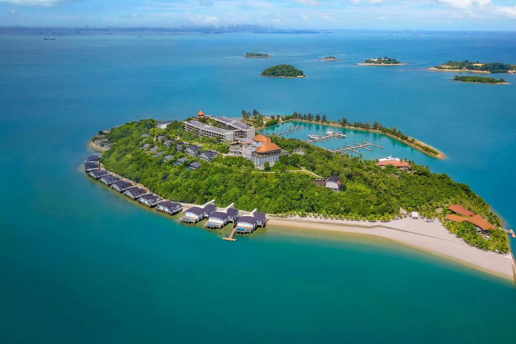 an island in the ocean with a resort on it at The Westin Nirup Island Resort & Spa in Belakangpandang