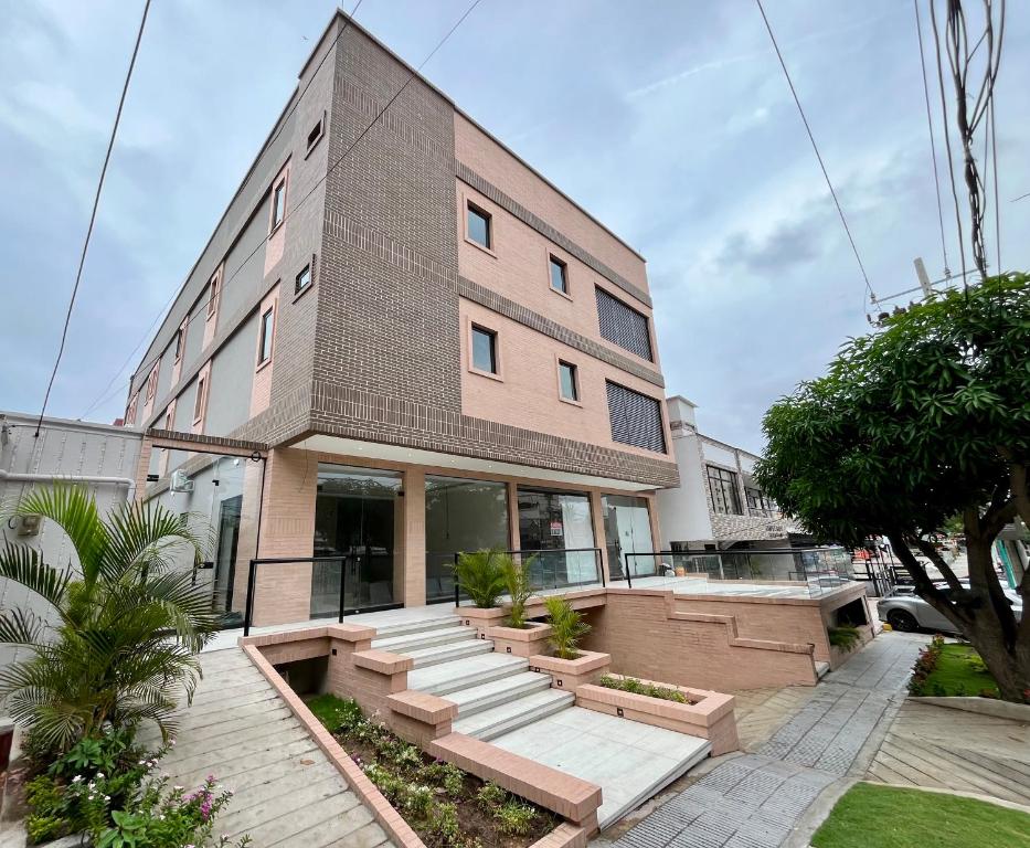 a large building with steps in front of it at BQ84 Urban Hotel in Barranquilla