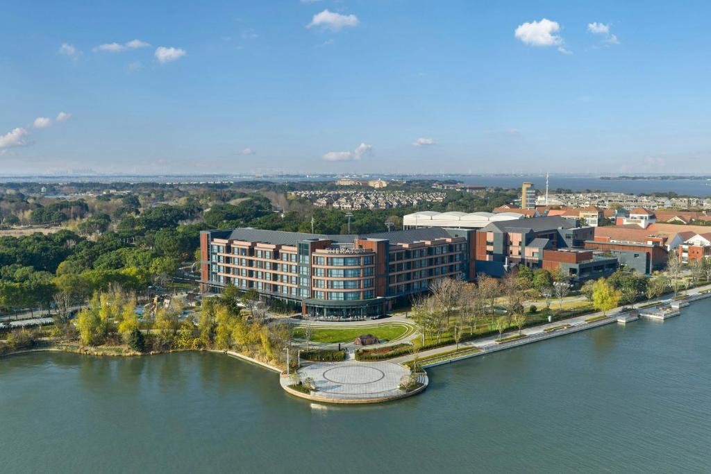 an aerial view of a building on the river at Sheraton Suzhou Yangcheng Lake in Suzhou